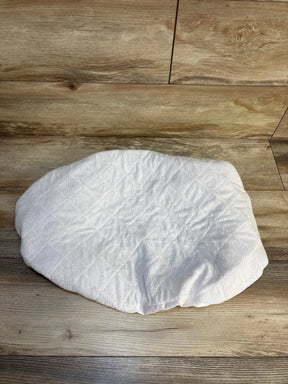 Top-down view of Biloban waterproof quilted bassinet mattress pad cover showing fitted elastic edges on wood floor