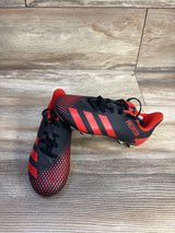Top front view of Adidas Predator 20.4 youth soccer cleats, black with red stripes and textured forefoot, on wood-look floor