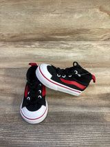 Front and side view of toddler Vans Racer Mid black canvas sneakers with red stripe and white rubber toe caps on wood floor