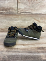 Pair of olive green and black toddler hiking boots with yellow laces on wooden floor