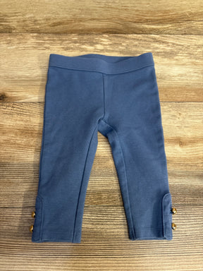Blue toddler leggings with gold button details on wooden surface, kids clothes resale