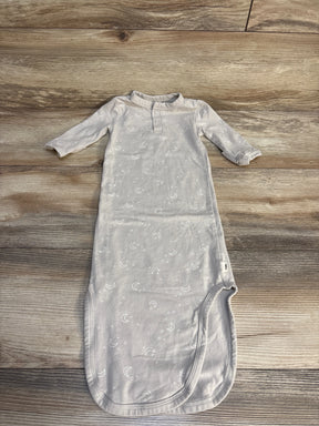 Light gray baby sleep gown with moon and star prints, long sleeves, laid on wood floor
