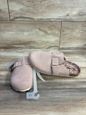 Pair of pink toddler slip-on clogs with adjustable strap and floral insole on wood surface, size 13