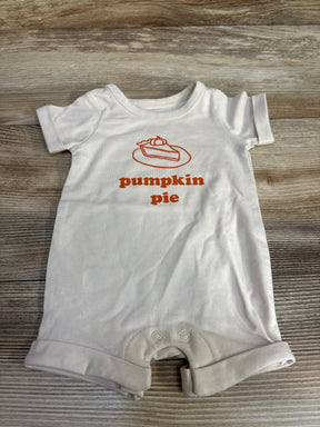 White baby romper with pumpkin pie slice graphic and orange text on wooden floor