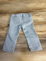Light blue toddler jeans with elastic waist, laid flat on wood floor — kids clothing resale
