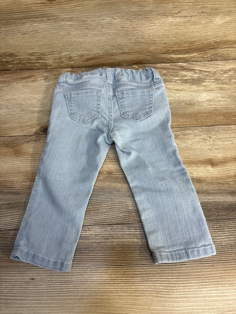Light blue toddler jeans with elastic waist, laid flat on wood floor — kids clothing resale