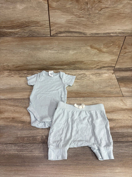 Flat lay of Modern Moments 2pc viscose bodysuit and pants set showcasing ribbed texture on wood flooring
