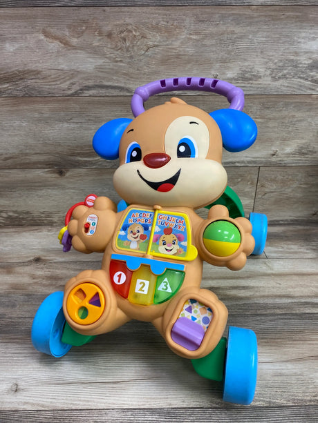Front view of Fisher Price Laugh and Learn Smart Stages Learn With Puppy Walker showing activity panels on a wood background