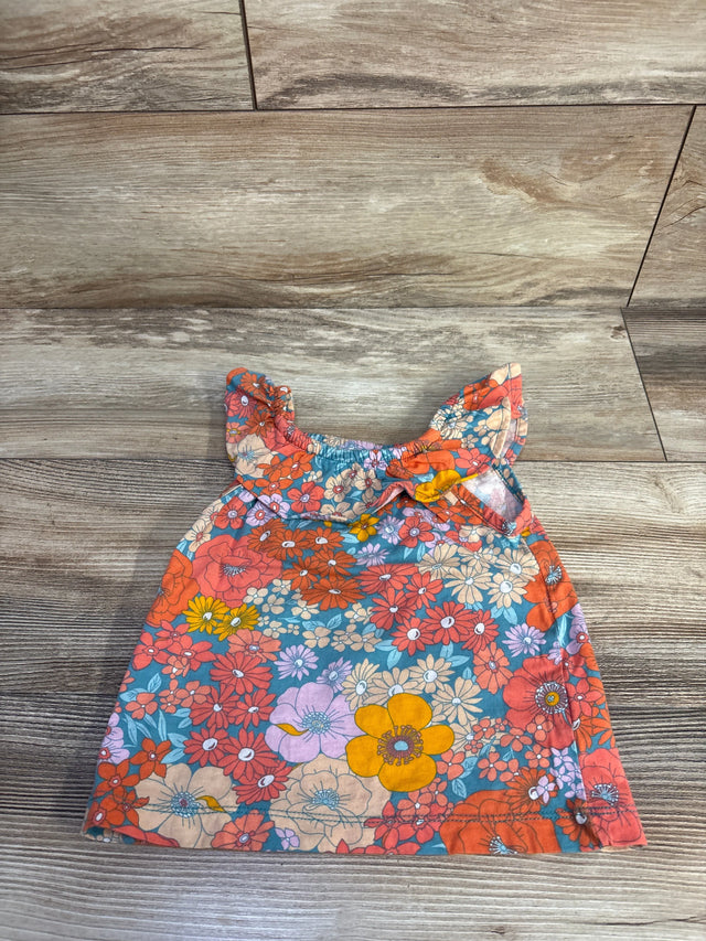 Top-down of Carter's girls' blue floral tank top size 2T with ruffled straps and multicolor flower print on wood background