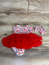 Baby girl red tutu dress with strawberry and Minnie Mouse print and matching headband on wooden floor