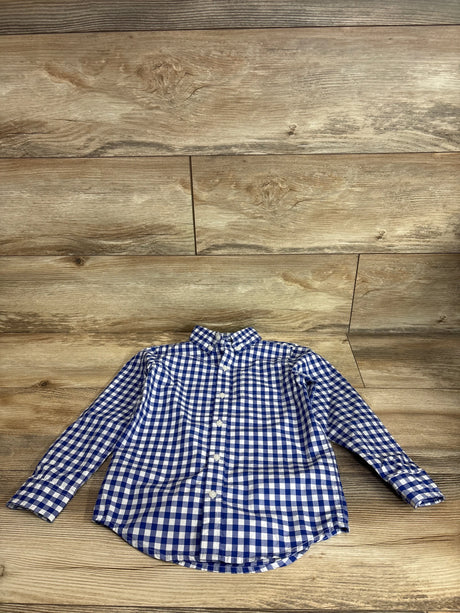 Flat lay of boys' Janie & Jack blue gingham poplin button-down shirt showing long sleeves and collar on light wood background