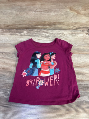 Flat lay of mauve Disney Girl Power toddler shirt with front graphic of three Disney characters and girl power text on wood background