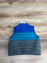 Children's sleeveless puffer vest in blue, teal, and gray colors on wooden surface