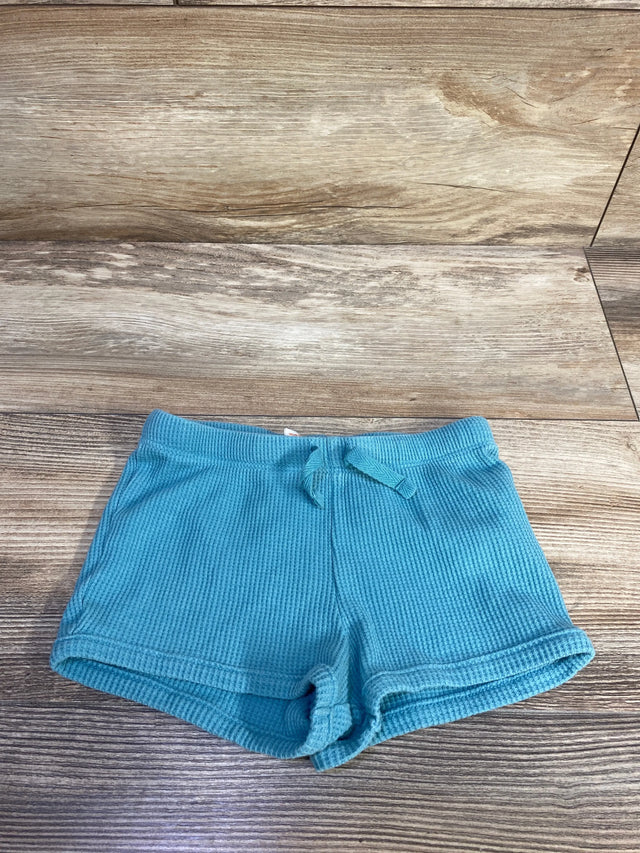Front view of teal toddler waffle-knit shorts (size 18M) showcasing elastic drawstring waist and rolled cuffs on wood background