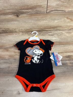 Black baby onesie with Snoopy and Baltimore Orioles logo, orange trim, on wood floor