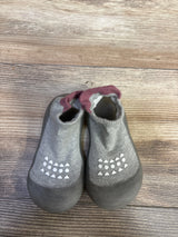 Top view of Bearbay grey infant sock shoes size 7/8C showing rubber toe caps and white non slip grip dots on wooden floor