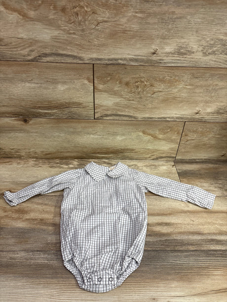 Top view of The Beaufort Bonnet Company white collared bubble romper, size 12/18m, with gray check pattern on wood