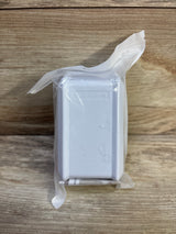 Front view of Eudemon white child safety outlet cover in sealed clear plastic packaging on wood background