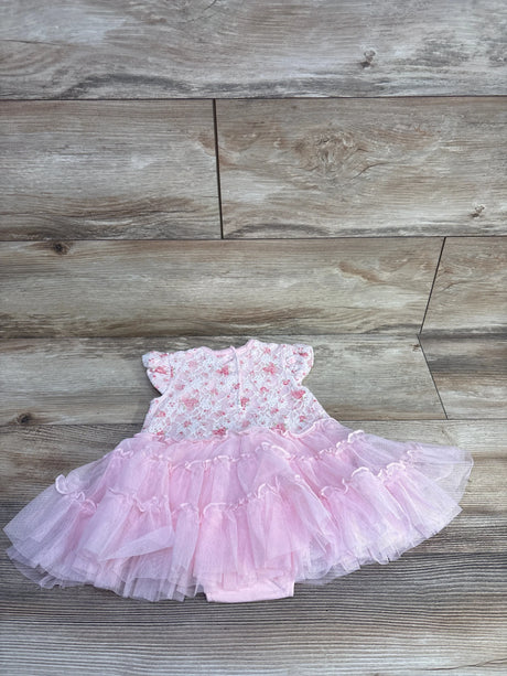 Flat lay of pink Little Me floral lace tutu popover bodysuit showing lace top and tiered tulle skirt on wood background