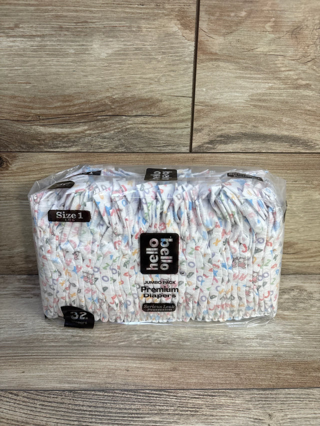Front view of Hello Bello size 1 premium diapers jumbo pack showing stacked diapers and 32 count packaging on wood background