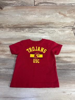 Red kids USC Trojans t-shirt with yellow logo, short sleeves on wood background