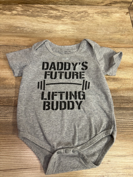 Front view of gray baby bodysuit showcasing Daddy’s Future Lifting Buddy graphic with snap closures on a wood background