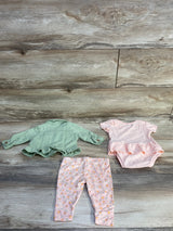 Flat lay of Nanette Baby 3-piece newborn set (size 0-3M) showing green jacket, pink ruffled bodysuit, and pink floral pants on wood background