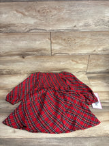 Red plaid kids dress with ruffled waist, laid on wood floor, resale clothing