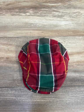 Red and green plaid baby flat cap for kids, festive holiday clothing accessory on wood background