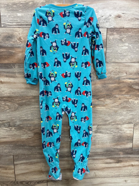 Blue children's one-piece pajama with gorilla and music-themed print on wood floor