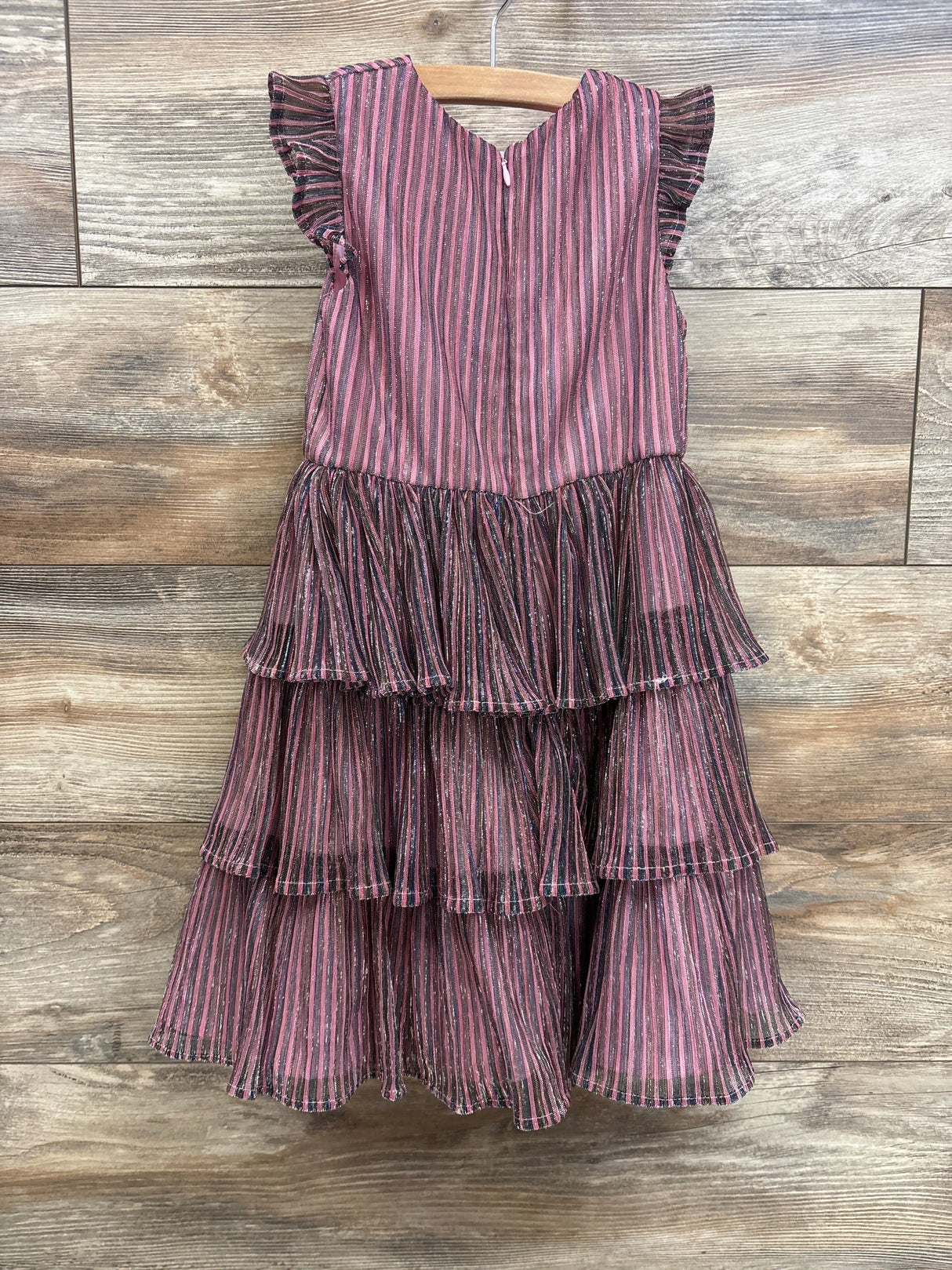 Pink and black striped ruffle dress for kids, tiered skirt, sleeveless, hanging on wood hanger