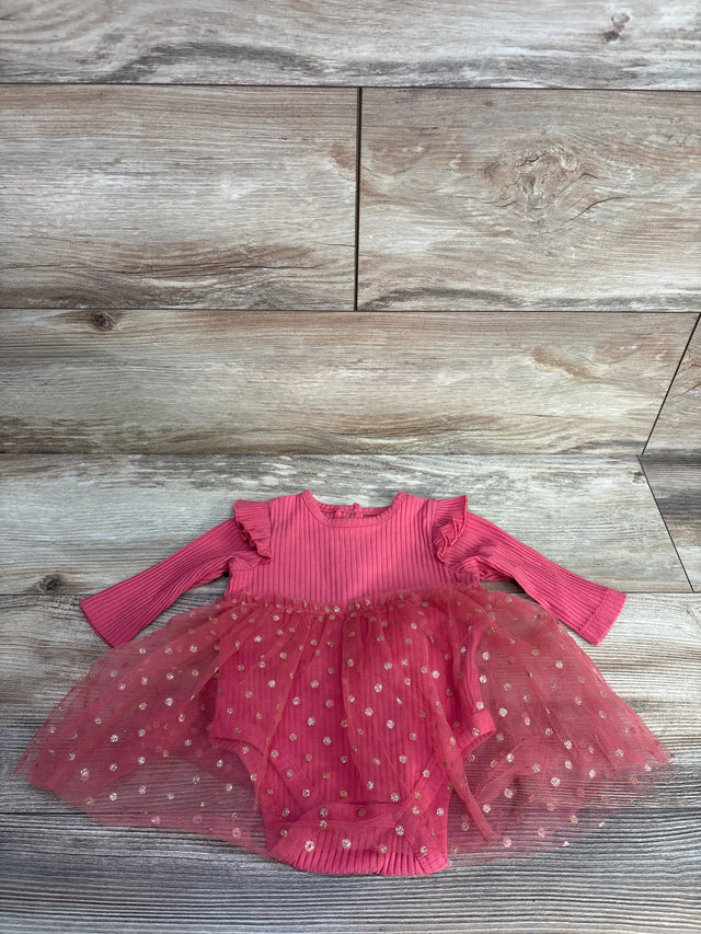 Pink baby girl dress with ruffled long sleeves and dotted tulle skirt on wood floor