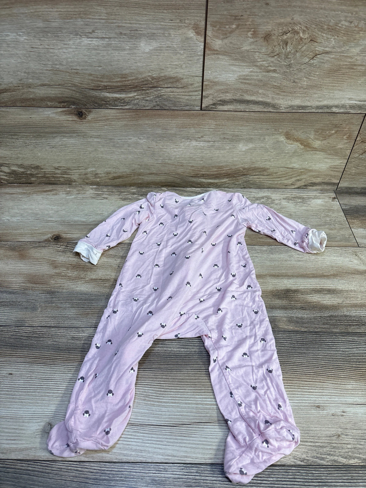 Top view of Disney Baby Minnie Mouse bamboo sleeper showcasing pink fabric, long sleeves, footed legs, and character print