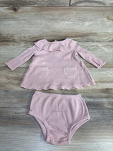Pink ribbed baby girl dress set with ruffle collar and matching bloomers on wood floor