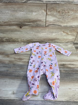 Top-down view of Carter's purple ribbed footed baby sleeper with orange and yellow floral print and long sleeves on wood background