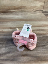 Pink knitted newborn booties with unicorn horns, perfect for baby gear and maternity outfits.