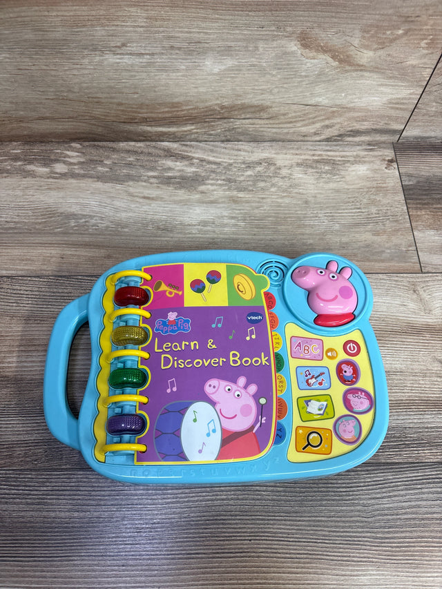 Vtech Peppa Pig Learn & Discover Book toy in blue with colorful buttons and interactive play features on wooden surface