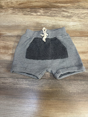 Striped baby shorts with front pocket and drawstring on wood background