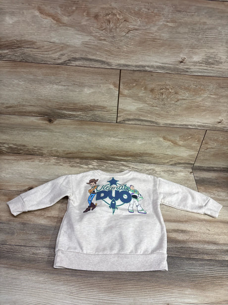 Front view of Disney Pixar Toy Story pullover sweatshirt in beige, size 18 months, featuring Woody and Buzz Lightyear graphic