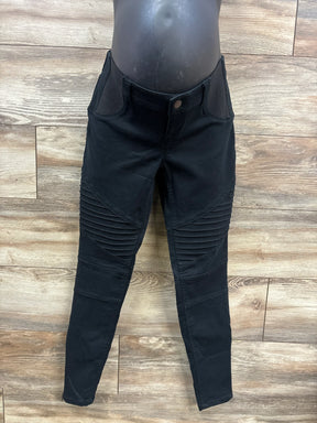 Black moto-style skinny jeans with ribbed knee detail on mannequin with wood floor background