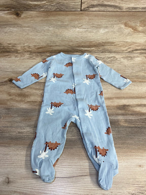 Flat-lay of blue Carter's 6M footed sleeper showing brown dinosaur print and front snap closure on wood plank background
