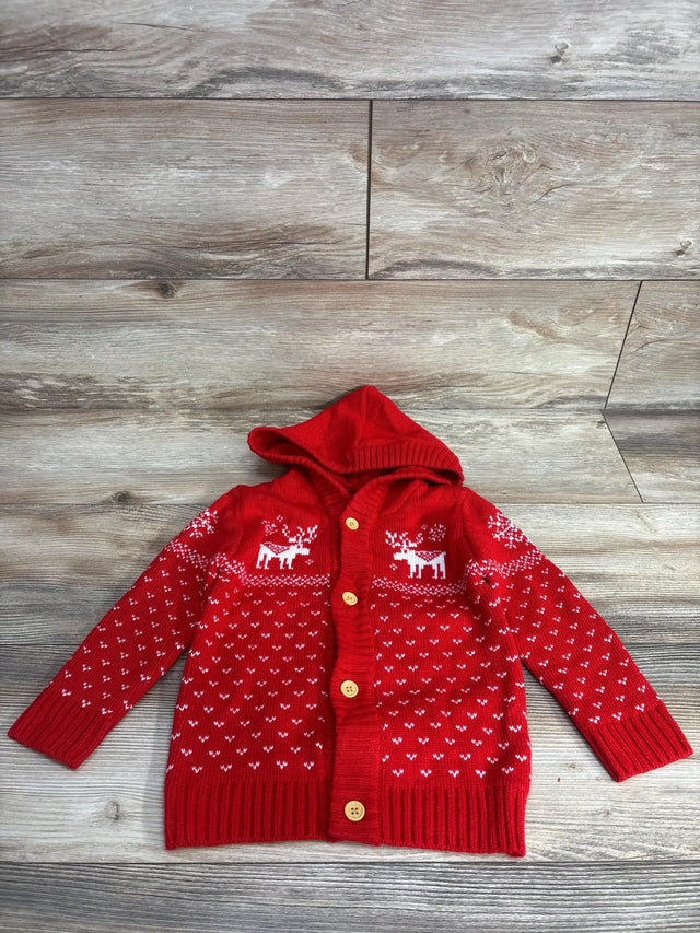 Red kids holiday cardigan with reindeer print, hood, and buttons on wood floor