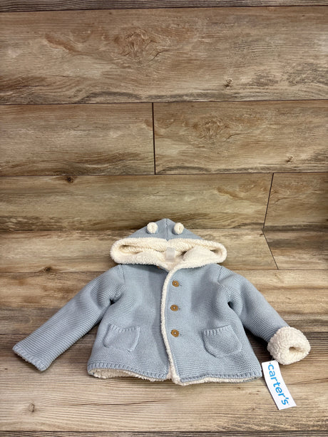 Carter's blue knit hooded cardigan with sherpa lining and bear ears on a wood background