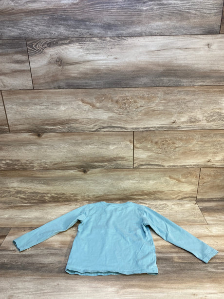Light blue long sleeve kids shirt, back view, on rustic wood background