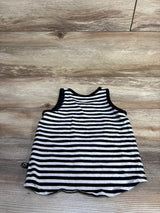 Black and white striped sleeveless baby dress on wood background