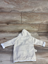 Back view of pale yellow newborn hooded terry cloth bath robe laid flat showing hood, long sleeves with rolled cuffs on wood plank background