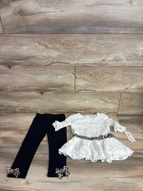 Girls lace top and leggings set with leopard print bows and belt, laid on wood background