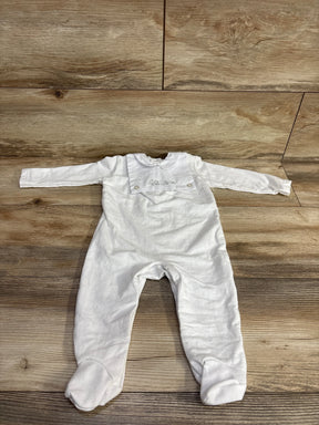 White long sleeve baby footed romper with embroidered animal design on wood background