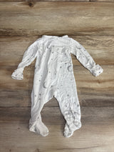 White long sleeve baby sleeper with moon and star print on wooden floor