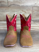 Pair of toddler brown cowboy boots with red paisley tops on wood floor